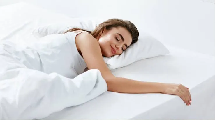 A woman sleeping comfortably on a freshly cleaned mattress