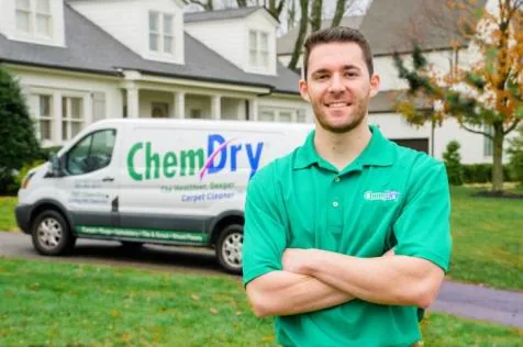 A Chem-Dry technician beside a Chem-Dry service van